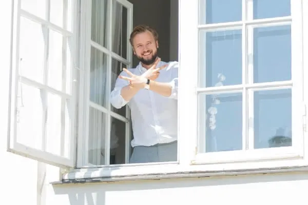 Our CEO standing in window smiling